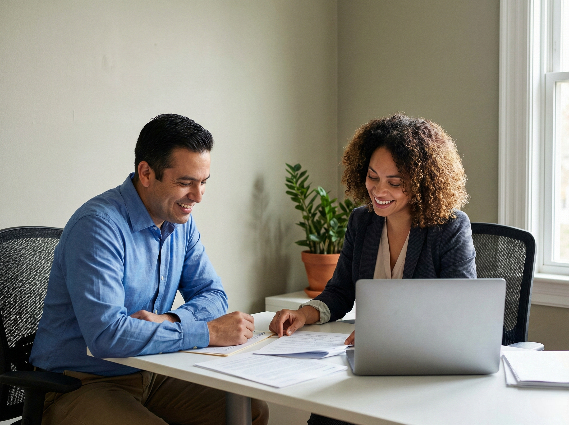 A realistic photo of a small business owner talking with an insurance agent while reviewing commercial auto policy documents.